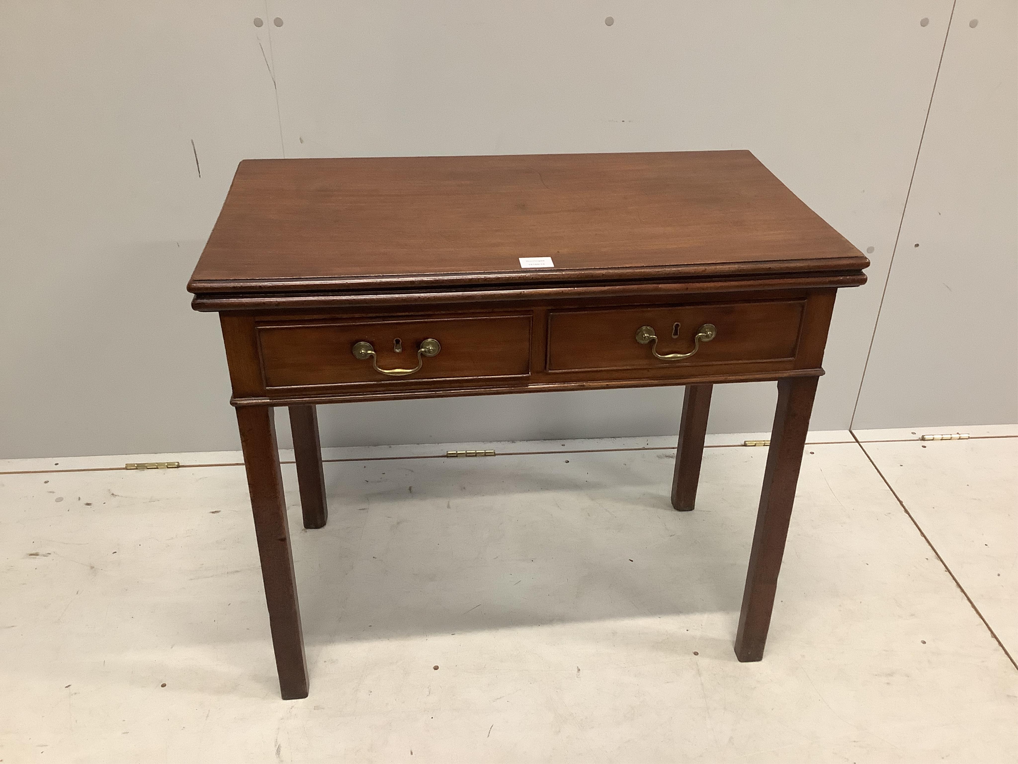 A George III rectangular mahogany two drawer folding tea table, width 83cm, depth 45cm, height 73cm. Condition - fair to good